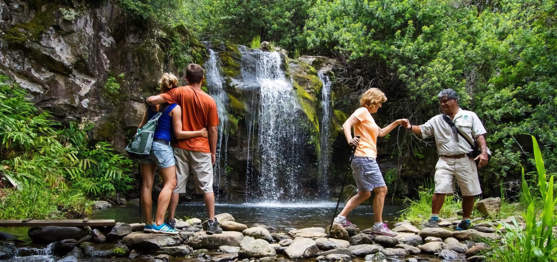 Tourists enjoying waterfall adventure in Hawaii