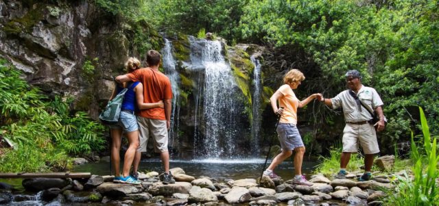 Tourists enjoying waterfall adventure in Hawaii