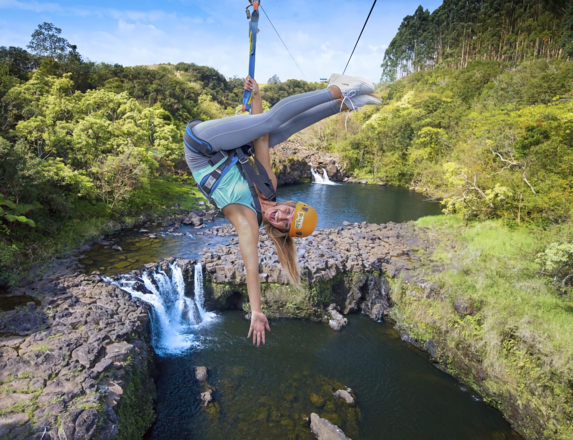 zip lining over a waterfall in hawaii