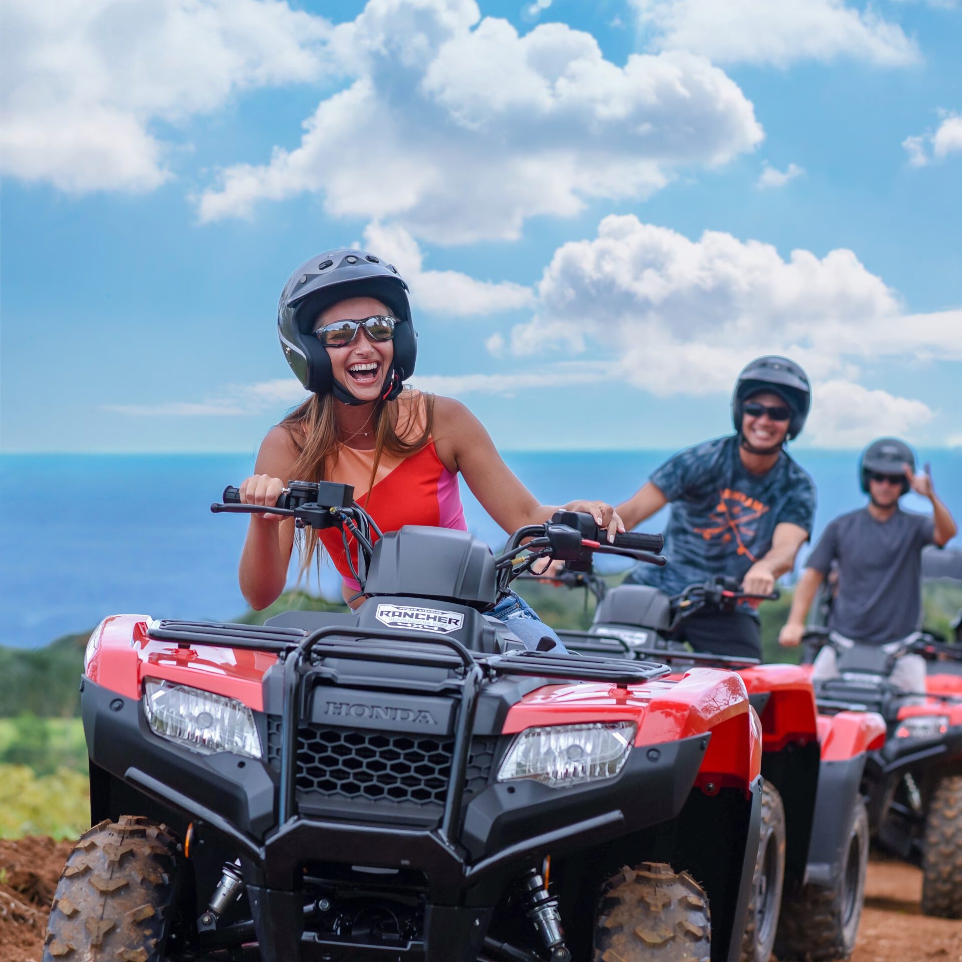 group of people riding ATV near the ocean in Hawaii