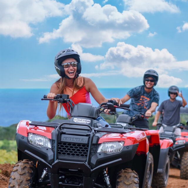 group of people riding ATV near the ocean in Hawaii