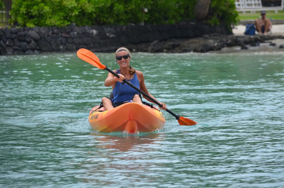 Women paddling a kayak in the Hawaiian ocean