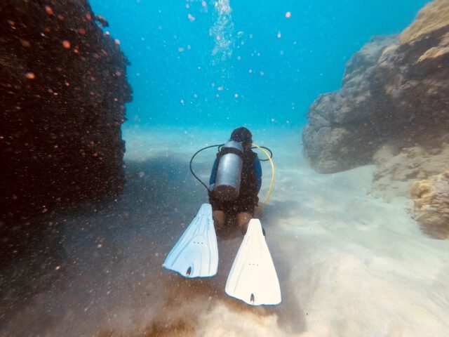 scuba diver lava tube and caves in hawaii