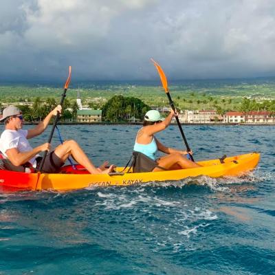 a person flying a kite in a boat on a body of water