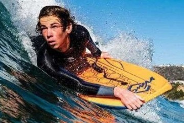 a man riding a wave on a surfboard in the water