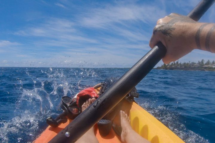 a person riding a surf board on a body of water