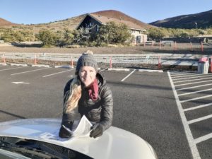 a person sitting in a parking lot