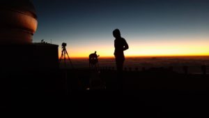 a person standing in front of a sunset