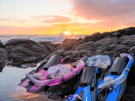 a group of people sitting at a beach