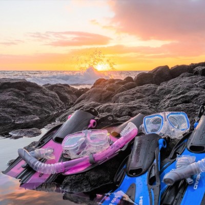 a group of people sitting at a beach