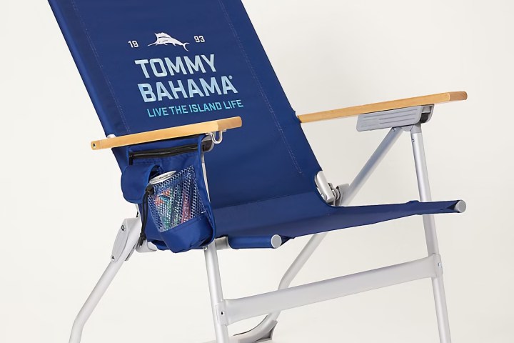 Blue Tommy Bahama beach chair with armrests and drink holder.